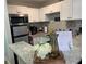 Bright kitchen with white cabinets, stainless steel appliances, granite countertops, and modern fixtures at 215 Piedmont Ne Ave # 2205, Atlanta, GA 30308