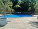 Outdoor pool area surrounded by lush trees, offering a refreshing escape and recreational space at 215 Piedmont Ne Ave # 2205, Atlanta, GA 30308