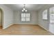 Well-lit dining room with classic wainscoting, stylish chandelier, and wood-look flooring at 4654 Webster Way, Acworth, GA 30101