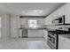 A well-lit kitchen featuring granite countertops, stainless steel appliances, and white cabinets at 4654 Webster Way, Acworth, GA 30101