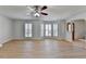 Inviting living room with many windows, ceiling fan, and beautiful wood-look floors at 4654 Webster Way, Acworth, GA 30101