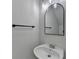 A simple powder room featuring modern lighting, a mirror, and a small sink at 4654 Webster Way, Acworth, GA 30101