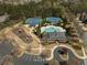 An aerial view of community pool and tennis courts with a playground and parking in a neighborhood surrounded by trees at 625 Aunt Lucy Sw Ln # 29, Smyrna, GA 30082