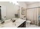 Clean bathroom featuring white tile, dark vanity, and a stylish shower curtain at 625 Aunt Lucy Sw Ln # 29, Smyrna, GA 30082