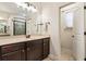 Bathroom vanity with dark wood cabinets, a large mirror, bright lights, and a door to the water closet at 625 Aunt Lucy Sw Ln # 29, Smyrna, GA 30082