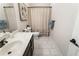 Clean bathroom featuring white tile, dark vanity, and a stylish shower curtain at 625 Aunt Lucy Sw Ln # 29, Smyrna, GA 30082