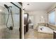 Bathroom with a walk-in shower, a soaking tub with tile surround, and dark wood cabinets at 625 Aunt Lucy Sw Ln # 29, Smyrna, GA 30082