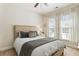 Comfortable bedroom featuring a neutral color scheme, plush bedding, and natural light from large windows at 625 Aunt Lucy Sw Ln # 29, Smyrna, GA 30082