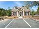 Exterior shot of brick clubhouse with black shutters, dormer windows, mature landscaping and a parking lot at 625 Aunt Lucy Sw Ln # 29, Smyrna, GA 30082