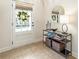 Entryway featuring tile flooring, decorative mirror and table, providing a stylish welcome to the home at 625 Aunt Lucy Sw Ln # 29, Smyrna, GA 30082