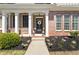 Inviting front porch with brick accents, decorative wreath, and charming lanterns, creating a warm welcome at 625 Aunt Lucy Sw Ln # 29, Smyrna, GA 30082