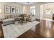 Spacious living room with hardwood floors, ceiling fan, and cozy furniture, creating an inviting and comfortable space at 625 Aunt Lucy Sw Ln # 29, Smyrna, GA 30082