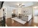 Cozy living room with hardwood floors, ceiling fan, and open layout, seamlessly connecting to the dining area at 625 Aunt Lucy Sw Ln # 29, Smyrna, GA 30082