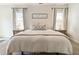 Bedroom with a plush bed, side tables with lamps, decor, and a large window for natural light at 625 Aunt Lucy Sw Ln # 29, Smyrna, GA 30082