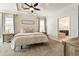 Bedroom with neutral paint, a sign on the wall, tray ceiling, and the Primary bathroom and vanity in the background at 625 Aunt Lucy Sw Ln # 29, Smyrna, GA 30082