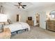 Main bedroom with neutral paint, a tray ceiling, a dresser, and a view to the seating area and Primary bath at 625 Aunt Lucy Sw Ln # 29, Smyrna, GA 30082