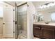 Walk-in shower with glass door and bench seat. Dark wood vanity with tan countertop at 625 Aunt Lucy Sw Ln # 29, Smyrna, GA 30082