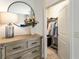 Walk-in closet with clothes rack, lighting, neutral paint, and a carpeted floor, adjacent to a wooden dresser at 625 Aunt Lucy Sw Ln # 29, Smyrna, GA 30082