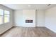 Cozy living room with wood-look floors, a modern fireplace, and windows providing natural light and warmth at 2654 Mourning Dove Drive (Lot 39), Grayson, GA 30017