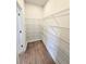 Walk-in pantry featuring wood-look flooring and metal shelving for organized storage and easy access at 2654 Mourning Dove Drive (Lot 39), Grayson, GA 30017