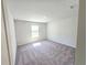 This bedroom features neutral carpeting and a sunlit window, creating a serene and inviting space at 2714 Mourning Dove Drive (Lot 33), Grayson, GA 30017