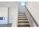 Staircase with hardwood steps and a modern railing leads to the upper level at 2714 Mourning Dove Drive (Lot 33), Grayson, GA 30017