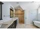 Elegant bathroom with double vanity, glass-enclosed shower, and a classic clawfoot tub at 415 Fayetteville Rd, Decatur, GA 30030