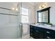 Modern bathroom featuring a glass-enclosed shower, black and white tile accents, and updated vanity at 415 Fayetteville Rd, Decatur, GA 30030