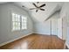 Bright bedroom featuring hardwood floors, a ceiling fan, and a large window for natural light at 415 Fayetteville Rd, Decatur, GA 30030