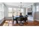 Sunlit dining room with hardwood floors, modern lighting, and fireplace at 415 Fayetteville Rd, Decatur, GA 30030