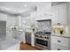 Updated kitchen featuring stainless steel appliances, bright cabinets, granite counters and tile backsplash at 415 Fayetteville Rd, Decatur, GA 30030