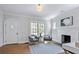 Cozy living room with fireplace, hardwood floors, arched door and bright windows at 415 Fayetteville Rd, Decatur, GA 30030