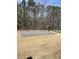 Community basketball court available for residents, adjacent to a tennis court and surrounded by tall pines at 744 Great Oak Pl, Villa Rica, GA 30180
