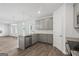 Open-concept kitchen with gray cabinetry, stainless steel appliances, granite countertops, and hardwood flooring at 744 Great Oak Pl, Villa Rica, GA 30180