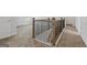 Carpeted stairwell landing featuring wooden and iron railing leading to the next floor at 744 Great Oak Pl, Villa Rica, GA 30180