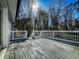 Exterior view of the expansive wooden back porch with white railings and stairs at 1238 Westboro Sw Dr, Atlanta, GA 30310