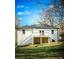 Backyard view of the home with a small white deck, stairs, and green lawn at 1238 Westboro Sw Dr, Atlanta, GA 30310