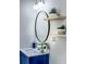 Close-up of bathroom vanity with round mirror and floating shelves at 1238 Westboro Sw Dr, Atlanta, GA 30310