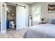 Bright bedroom featuring a barn door that opens to a well-appointed bathroom with modern fixtures at 1238 Westboro Sw Dr, Atlanta, GA 30310