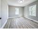 Bright bedroom with wood-look floors, neutral walls, bright windows, and white trim at 1238 Westboro Sw Dr, Atlanta, GA 30310