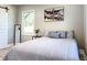 Bedroom with wood-look flooring, neutral walls, an abstract art piece, and natural light at 1238 Westboro Sw Dr, Atlanta, GA 30310