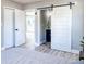 Bedroom showcasing the barn door entry to the bathroom, with stylish fixtures and design at 1238 Westboro Sw Dr, Atlanta, GA 30310