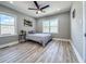 Cozy bedroom featuring wood-look flooring, neutral decor, a ceiling fan and bright windows at 1238 Westboro Sw Dr, Atlanta, GA 30310