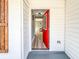 Inviting entryway with a bright red door and view of the interior's modern finishes and wood-look floors at 1238 Westboro Sw Dr, Atlanta, GA 30310