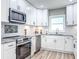 Bright kitchen with white cabinets, granite countertops, stainless steel appliances, and a window view at 1238 Westboro Sw Dr, Atlanta, GA 30310