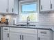 Kitchen sink with a view, granite countertops, and white cabinets at 1238 Westboro Sw Dr, Atlanta, GA 30310