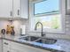 Kitchen sink with a view, granite countertops, and white cabinets at 1238 Westboro Sw Dr, Atlanta, GA 30310