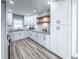 Modern kitchen boasting white cabinetry, granite countertops, stainless appliances and stylish wood shelves at 1238 Westboro Sw Dr, Atlanta, GA 30310