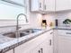 Kitchen close-up of granite counters, stainless steel sink, and updated faucet at 1238 Westboro Sw Dr, Atlanta, GA 30310