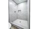 Modern tiled shower features a shower head, shower faucet, tile-lined niche, and tile floor at 1238 Westboro Sw Dr, Atlanta, GA 30310